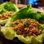 Close-up of delicious chicken lettuce wraps filled with savory ground chicken and topped with green onions.