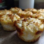 Close-up of freshly baked cottage cheese egg cups starbucks hack, topped with melted and slightly browned cheese.