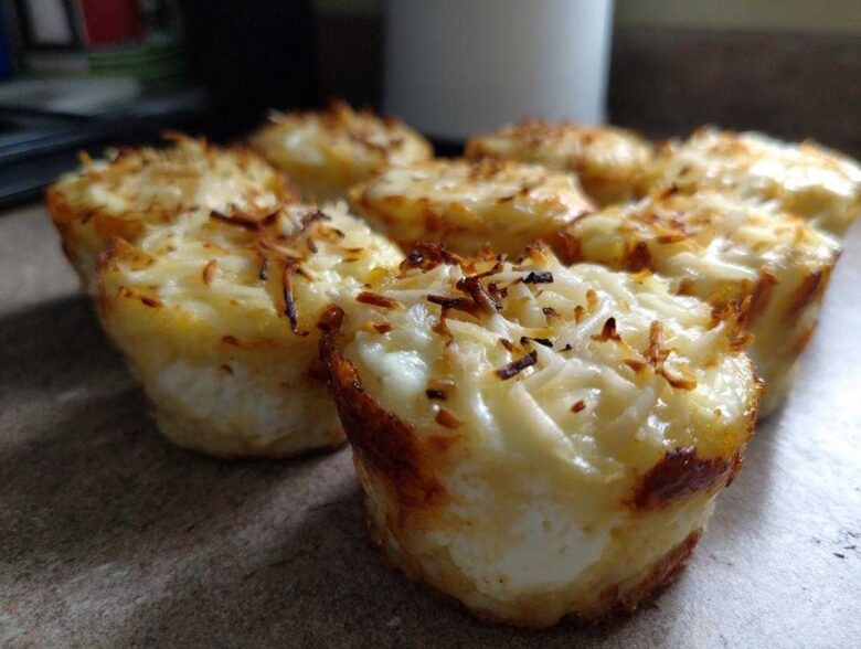 Close-up of freshly baked cottage cheese egg cups starbucks hack, topped with melted and slightly browned cheese.
