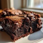 Close-up of a fudgy sweet potato brownies square showing its dense, moist interior and chocolate chips.