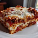 Close-up of a hearty slice of Lasagna with Cottage Cheese showing layers of pasta, meat sauce, and melted cheese topping.