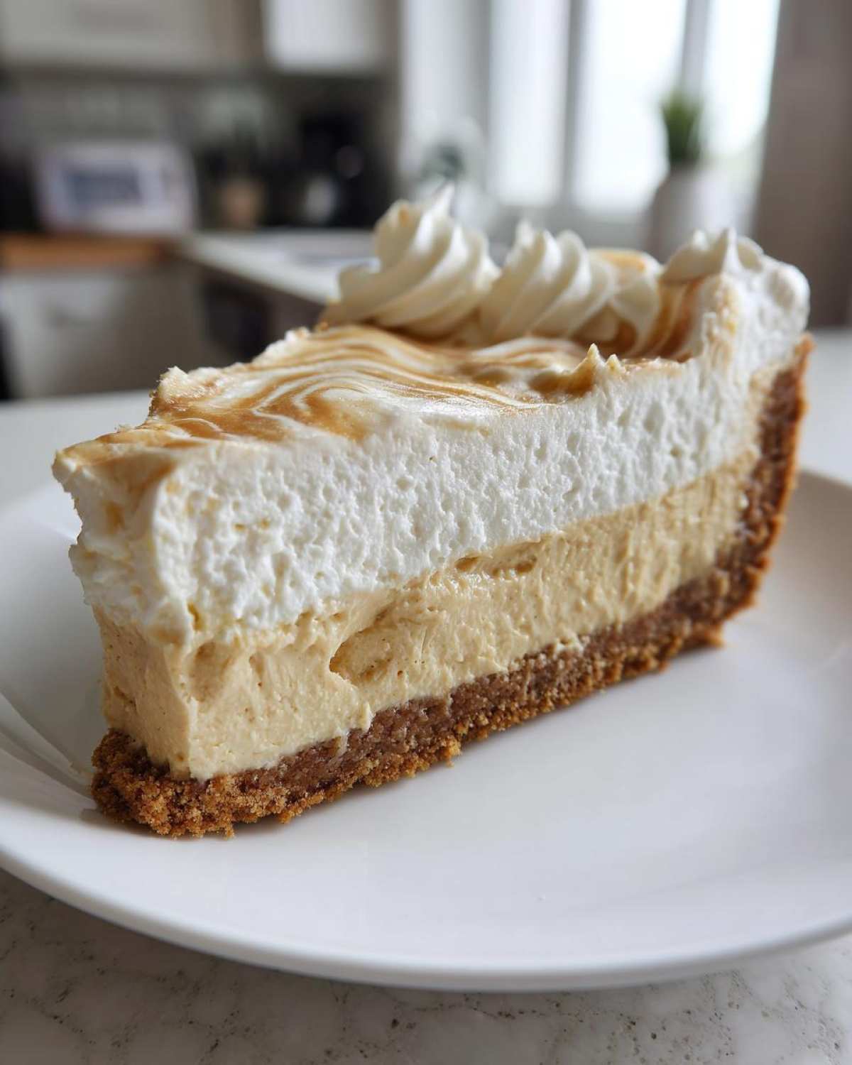 A tall slice of no-bake peanut butter pie featuring a graham cracker crust, creamy filling, and fluffy whipped topping.