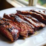 Close-up of medium-rare sliced steak, showing a juicy interior, prepared with carne asada marinade.
