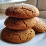 A stack of three soft applesauce cookies, generously coated in sparkling sugar crystals.