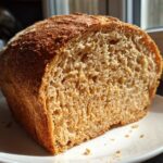 Close-up of the soft, airy crumb structure of a freshly baked whole wheat bread loaf.
