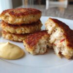 Stack of golden brown Air Fryer Crispy Crab Cakes served with a dollop of yellow lemon aioli.