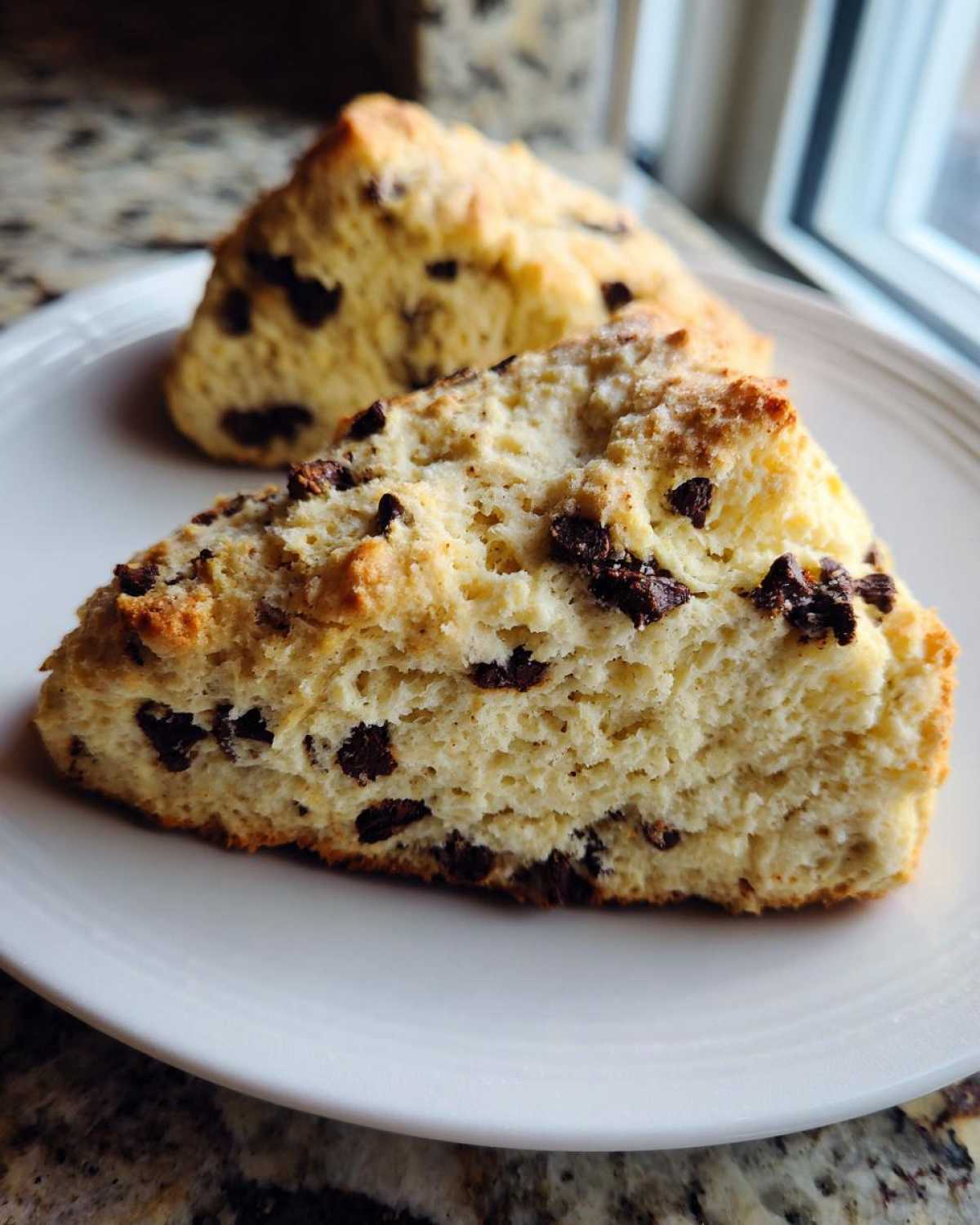 Close-up view of the fluffy interior texture of Gluten-Free Chocolate Chip Scones studded with dark chocolate chips.