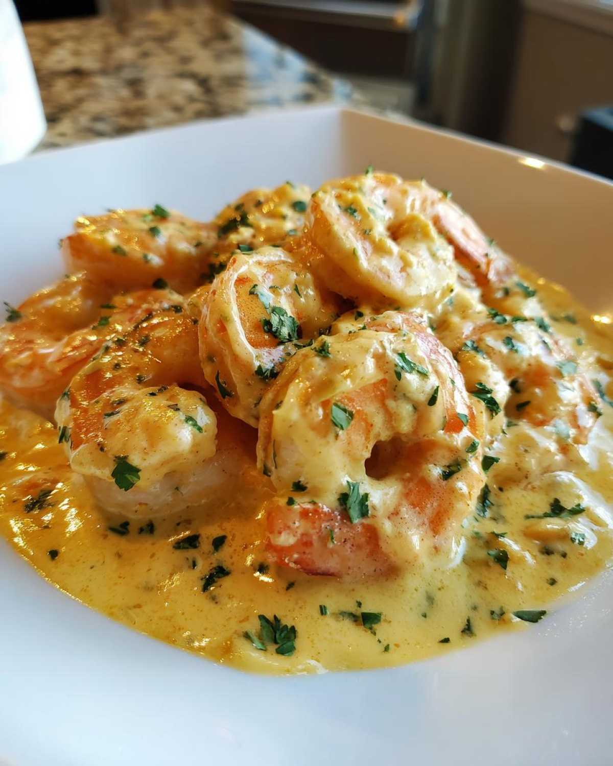 Close-up of succulent shrimp coated in a rich, creamy garlic butter sauce, garnished with parsley, part of the Instant Pot Creamy Garlic Butter Shrimp Scampi.