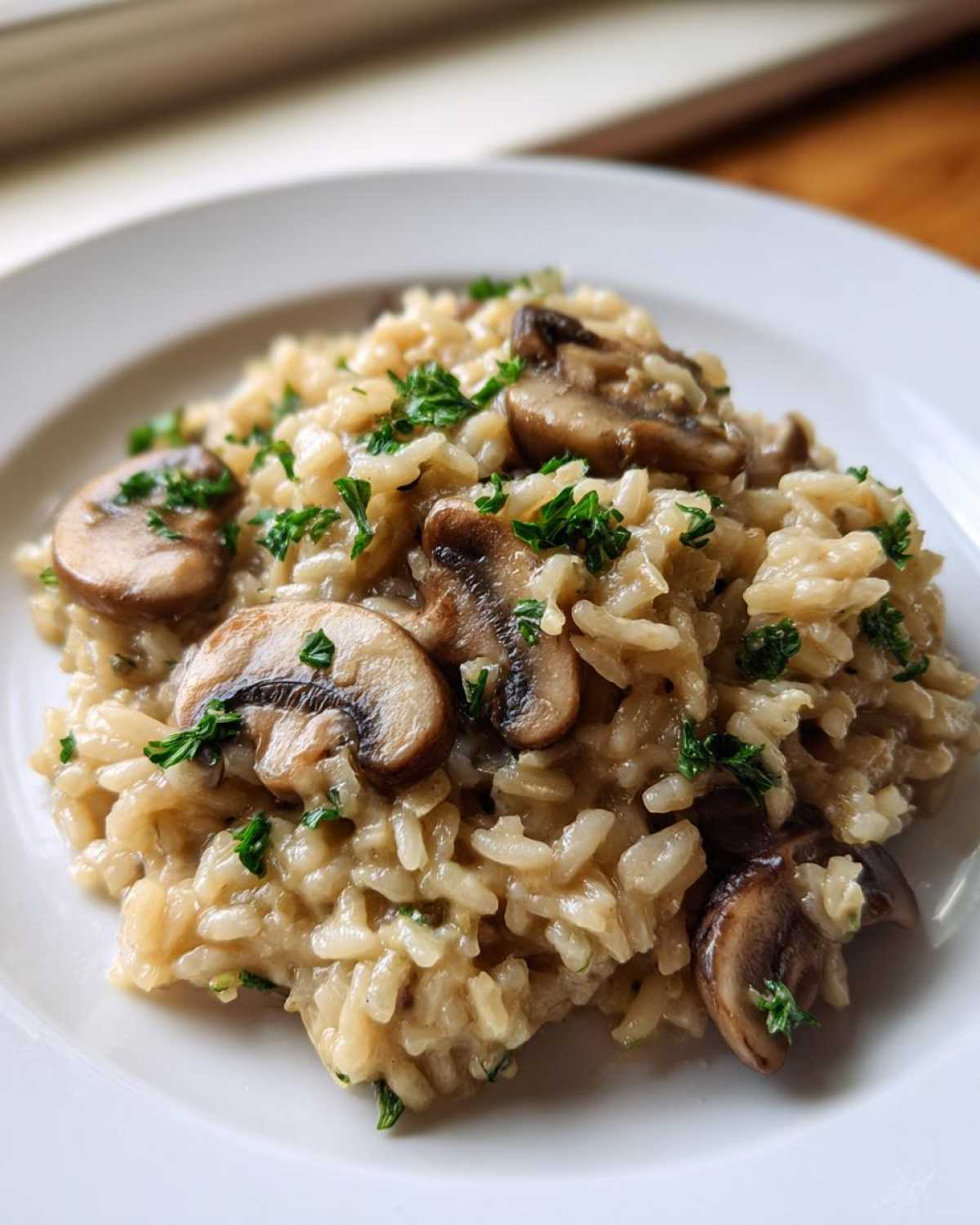 A close-up of creamy Instant Pot Creamy Mushroom Risotto topped with sliced mushrooms and fresh parsley.