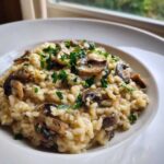 Close-up of creamy Instant Pot Creamy Mushroom Risotto topped with sautéed mushrooms and fresh parsley.