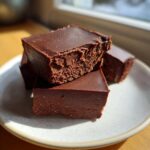 Close-up of stacked No-Bake Espresso Chocolate Fudge Squares showing their dense, rich texture.