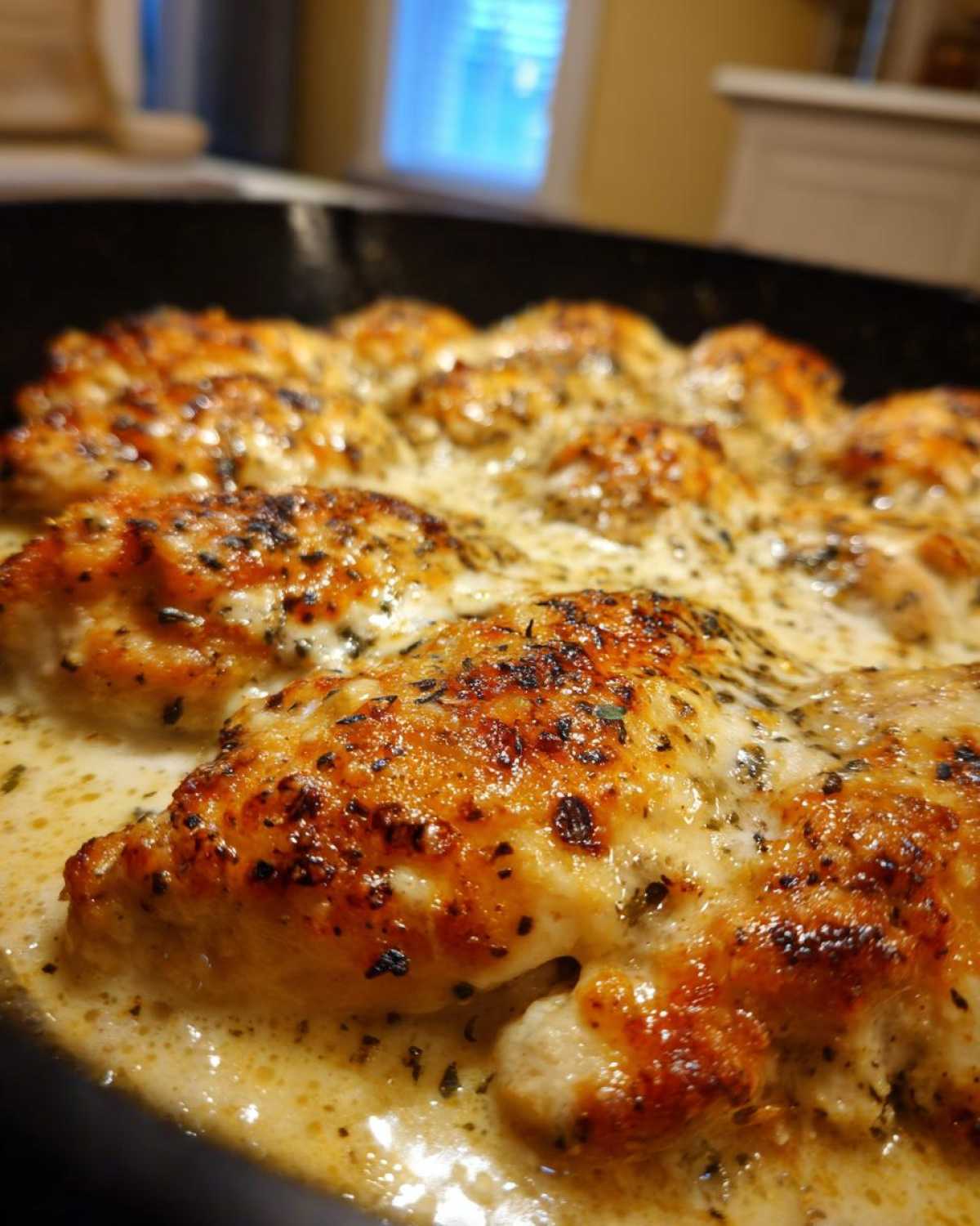 Close-up of golden-brown chicken pieces baked in a rich, creamy garlic parmesan sauce, part of the Keto Creamy Garlic Parmesan Chicken Bake.