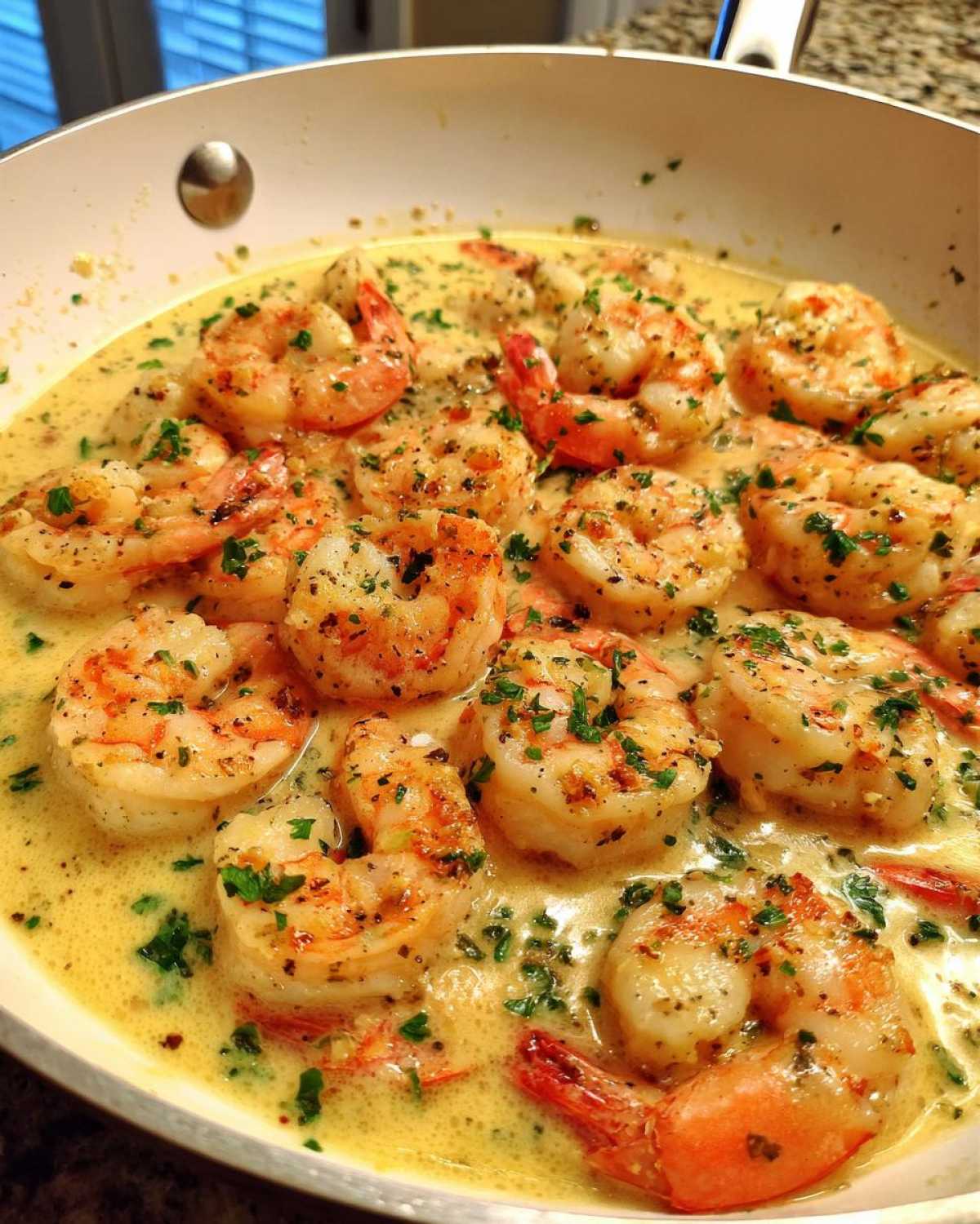 Plump shrimp simmering in a rich, creamy garlic sauce, garnished with parsley, featured in a Keto Creamy Garlic Shrimp Skillet.