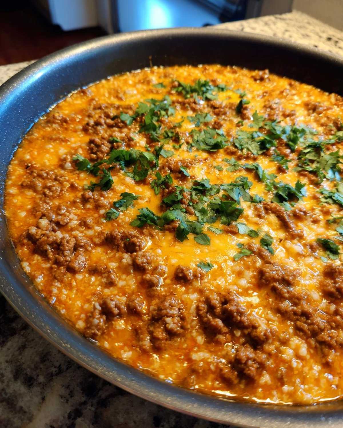 Close-up of the finished Keto Creamy Taco Skillet with cauliflower rice, ground beef, melted cheese, and fresh cilantro.