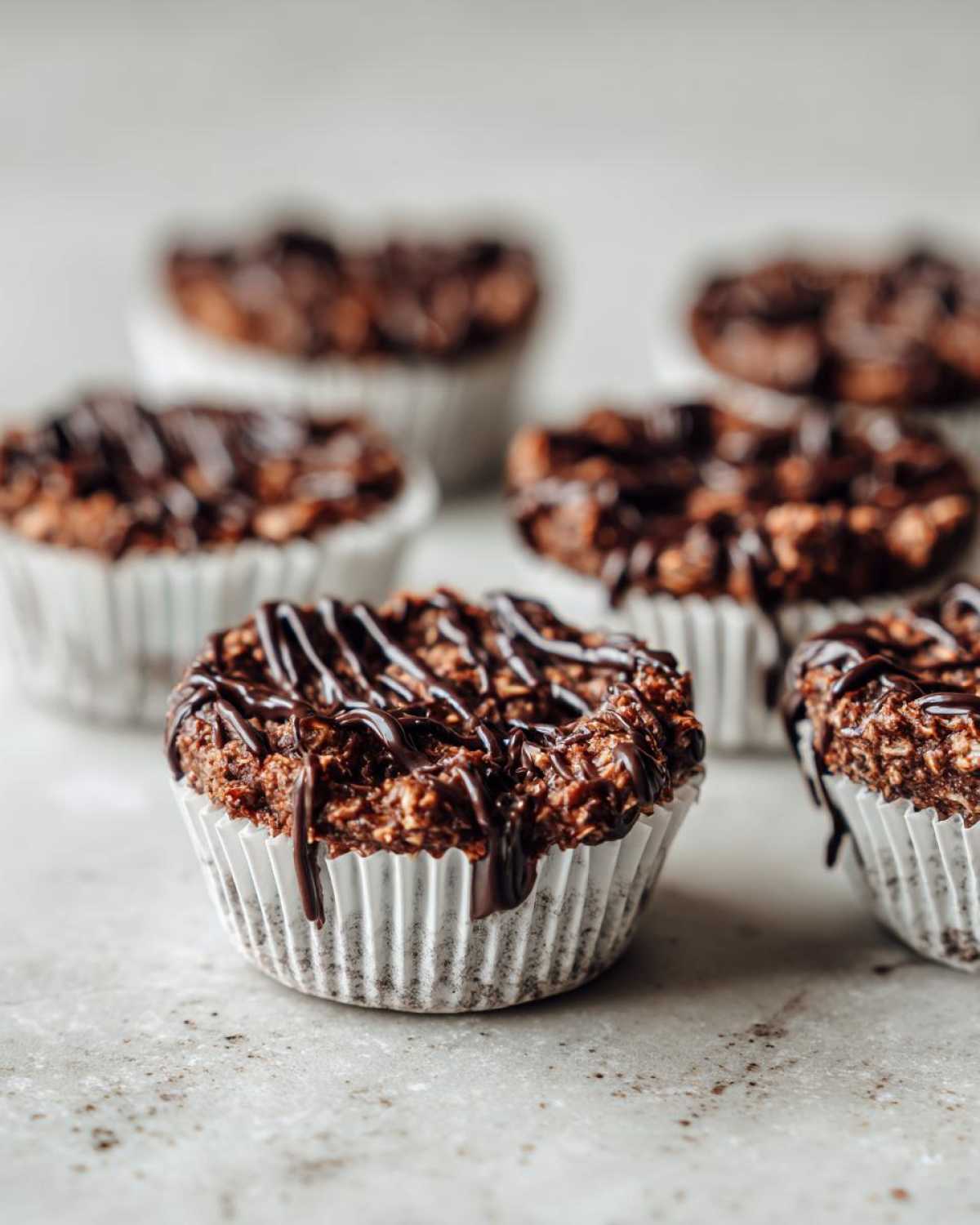 Close-up of a No-Bake Chocolate Coconut Protein Cup topped with a rich chocolate drizzle.