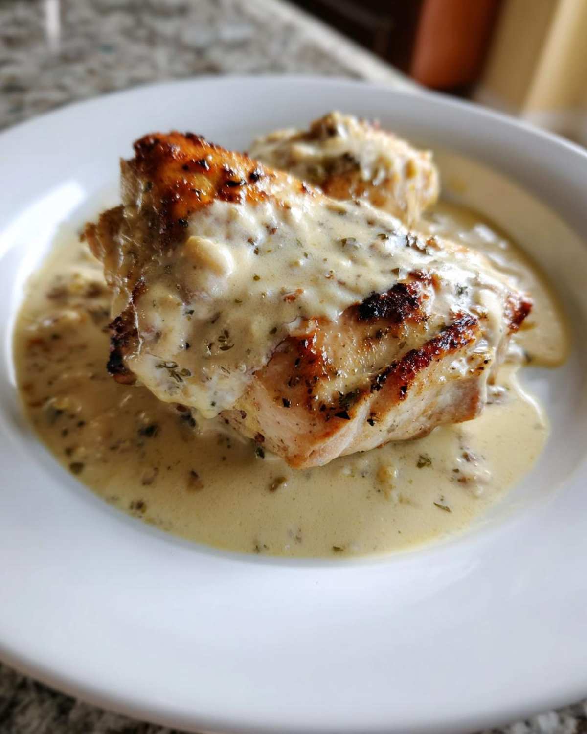 Close-up of seared chicken breasts topped with a creamy sauce, part of the One-Pan Creamy Coconut Lime Chicken recipe.