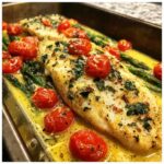 Close-up of One-Pan Creamy Garlic Butter Tilapia baked with roasted cherry tomatoes and asparagus.