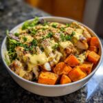 Close-up of a Chicken Sweet Potato Power Bowl featuring grilled chicken, roasted sweet potatoes, and a generous Chicken Sweet Potato Power Bowl Tahini Drizzle.