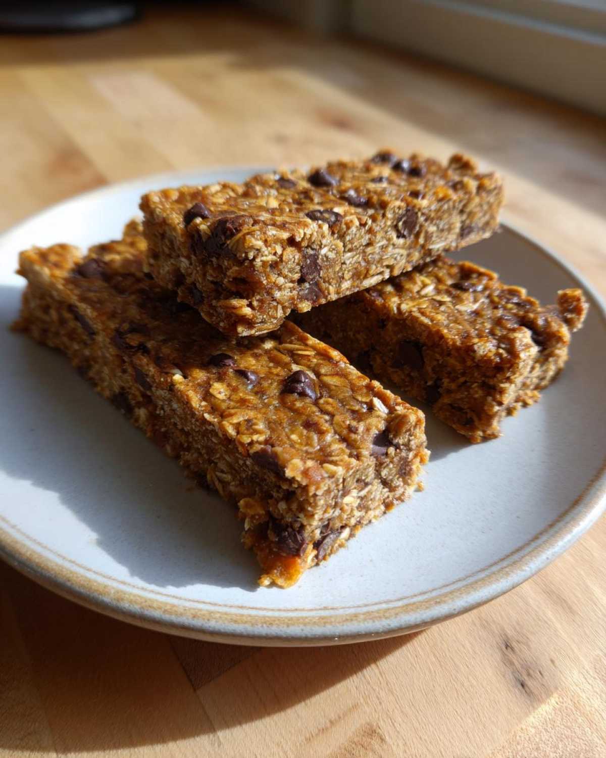 Three stacked homemade chocolate chip bars, perfect for Easy Homemade High-Protein Snack Bar Ideas.