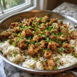 Close-up of One-Skillet Fried Chicken Rice topped with crispy chicken pieces and green onions.