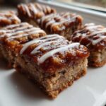 Close-up of several squares of Salted Caramel Pop Tart Bars made with cinnamon sourdough, topped with caramel and white icing drizzle.