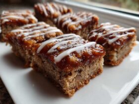 Close-up of several squares of Salted Caramel Pop Tart Bars made with cinnamon sourdough, topped with caramel and white icing drizzle.