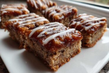 Close-up of several squares of Salted Caramel Pop Tart Bars made with cinnamon sourdough, topped with caramel and white icing drizzle.