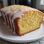 A loaf of Starbucks Copycat Lemon Loaf - Browned Butter Blondie, drizzled with white icing and topped with lemon zest.