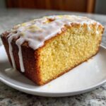 Close-up of a slice of Starbucks Copycat Lemon Loaf with browned butter blondie texture and thick white icing.